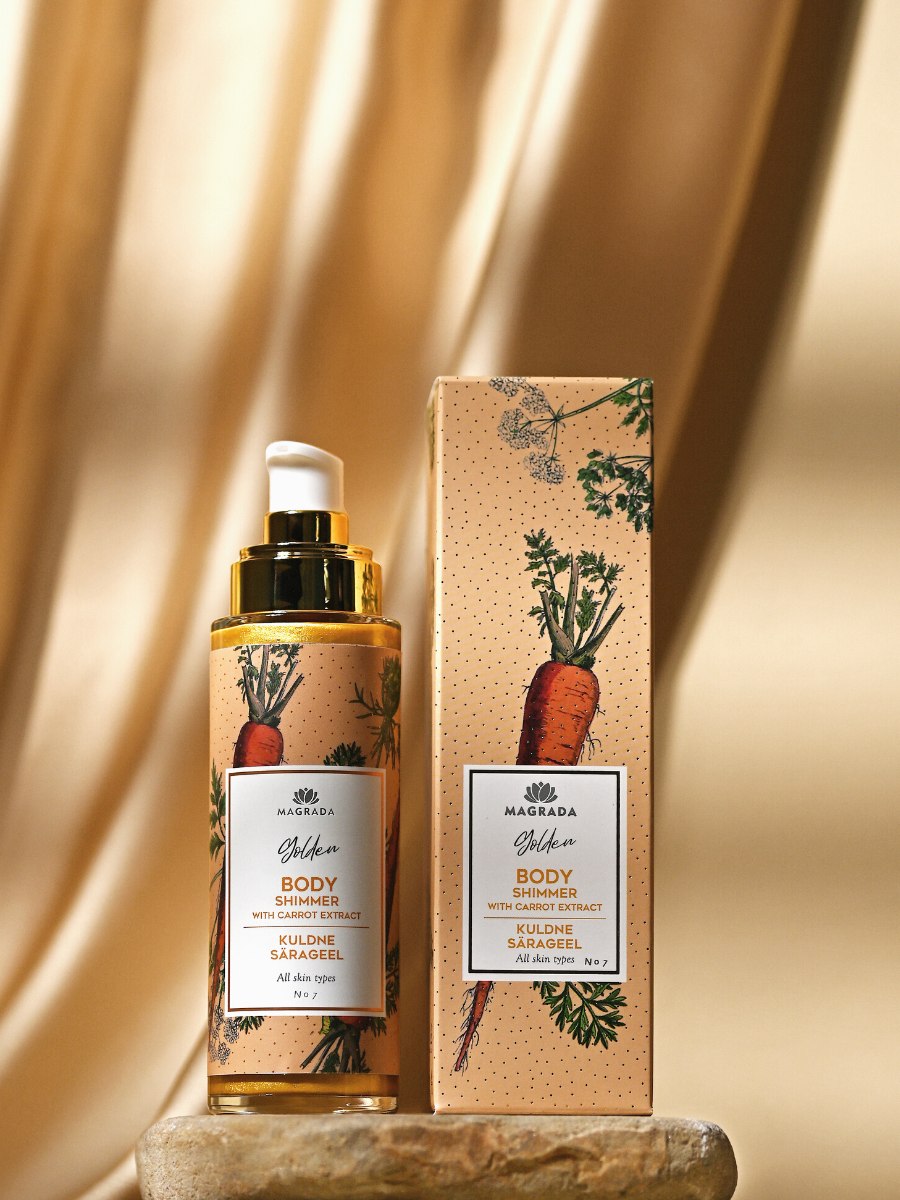 Magrada Organic Cosmetics golden body shimmer with carrot extract bottle and matching box on beige background