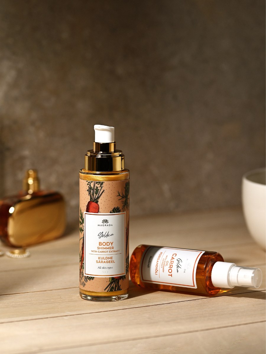 Magrada Organic Cosmetics body oil and carrot spray bottles on wooden surface with soft background
