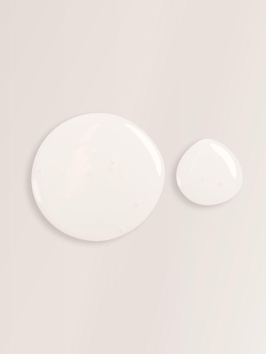 Two drops of creamy white Linden Flower Shampoo from Magrada Organic Cosmetics on a beige background