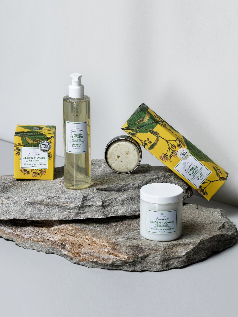 Magrada Organic Cosmetics Linden Flower Shampoo Bar and hair care products displayed on natural stone slabs