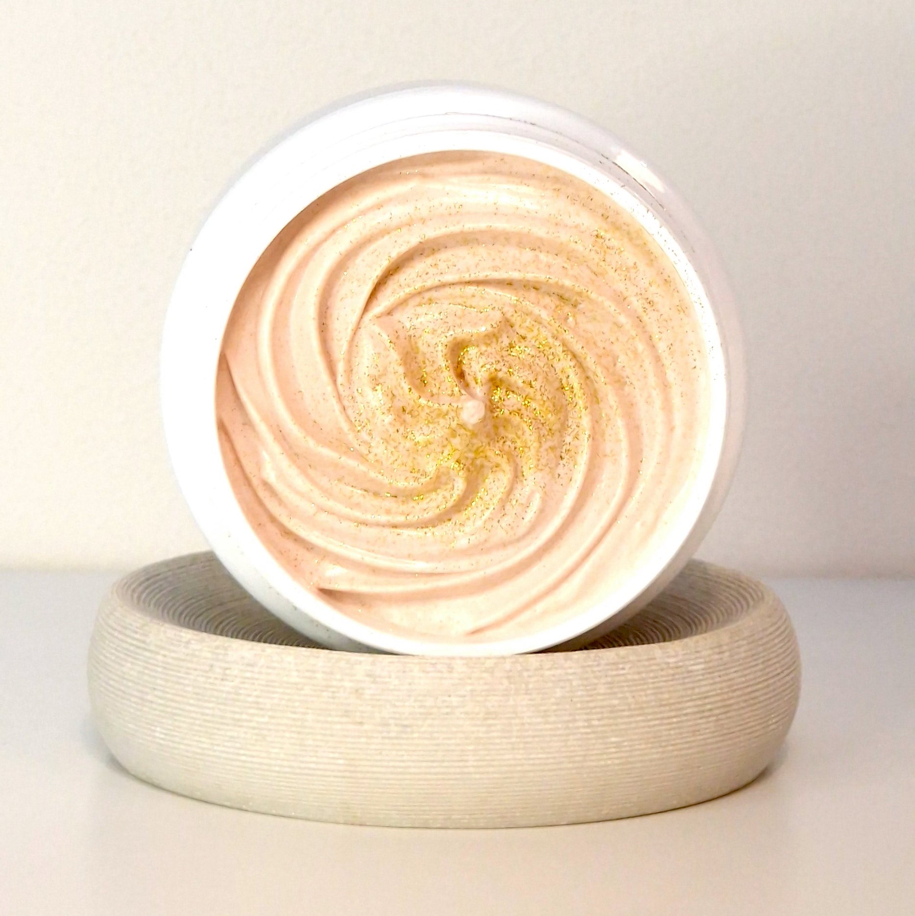 North Beauty whipped body butter cream in a white jar with golden shimmer on top
