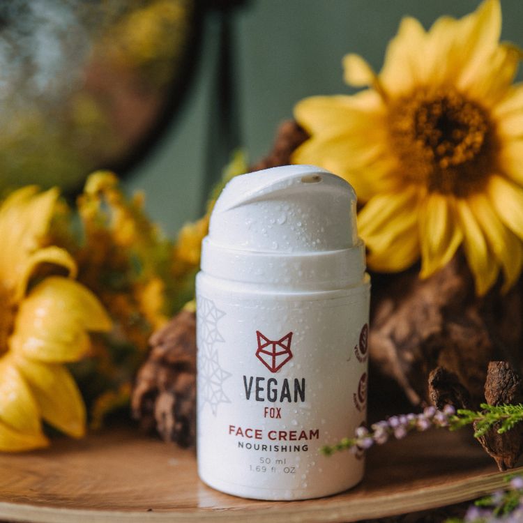 Vegan Fox nourishing face cream hydrating in a white pump bottle with floral background